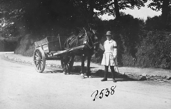 Member of the First World War Womens Land Army standing with a horse and cart, St Clement, Cornwall. Probably May 1918