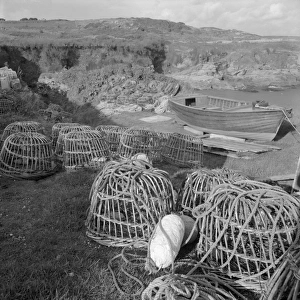 Lobster pots and boat, Prussia Cove, St Hilary, Cornwall. 1970