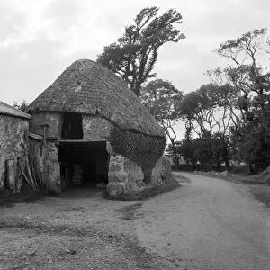 Thatched cob building by roadside, Lanarth, St Keverne, Cornwall. 1971