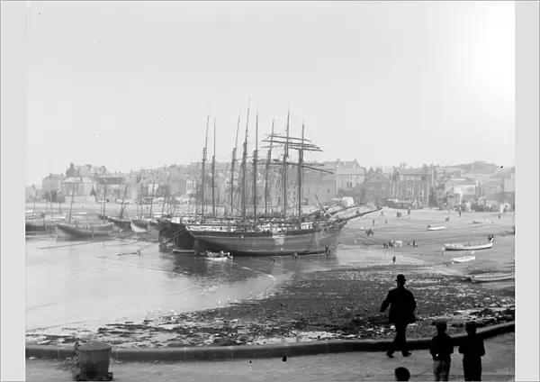 Three schooners beached in the harbour at low tide, St Ives, Cornwall. Early 1900s