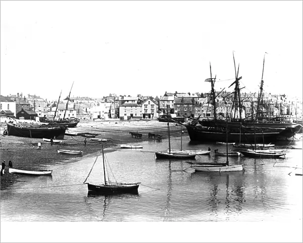 Fishing boats and schooners beached in St Ives harbour, Cornwall. Early 1900s