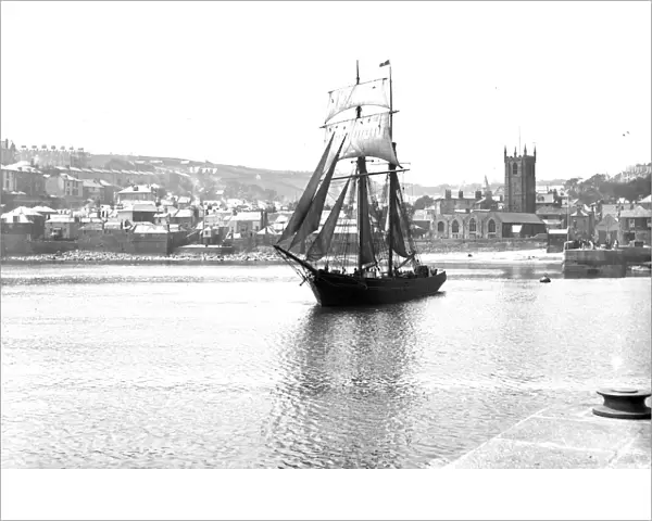 Unidentified topsail schooner underway leaving St Ives harbour, Cornwall. Early 1900s