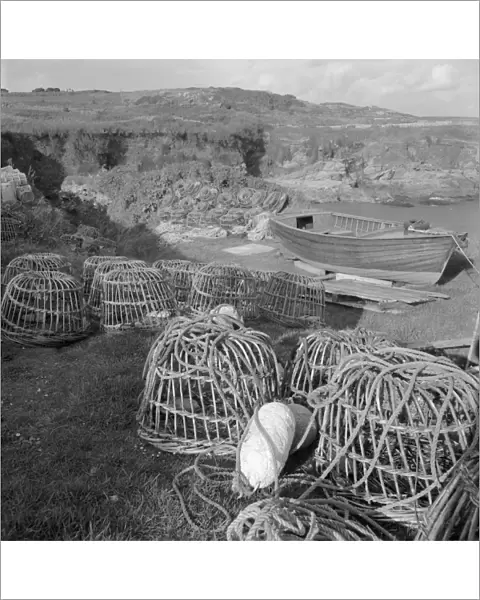 Lobster pots and boat, Prussia Cove, St Hilary, Cornwall. 1970