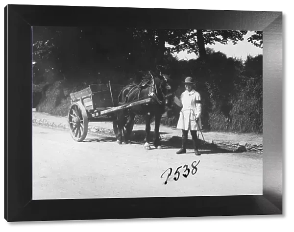 Member of the First World War Womens Land Army standing with a horse and cart, St Clement, Cornwall. Probably May 1918