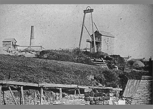 Two Engine houses at Wheal Sparnon with cottages in the background, Redruth, Cornwall. Around 1865