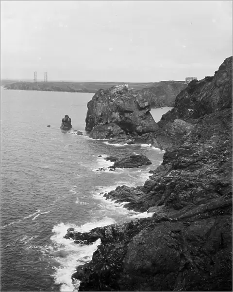 A distant view of the four wooden Marconi wireless towers at Poldhu, Mullion, Cornwall from Mullion Cove along the cliff. 1908