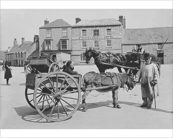 A donkey and cart in Market Square, St Just in Penwith, Cornwall. Early 1900s
