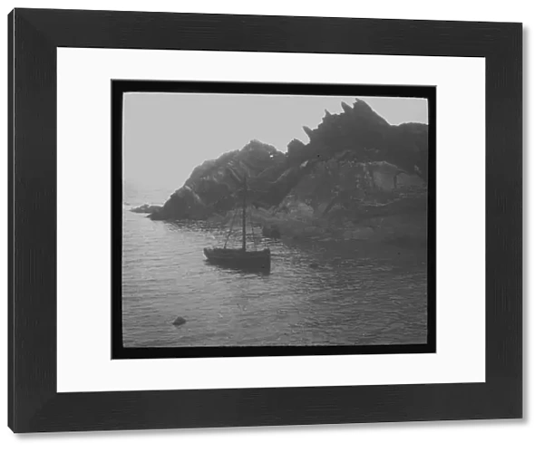 Fishing boat in a cove, probably Polperro, Cornwall. Around 1900