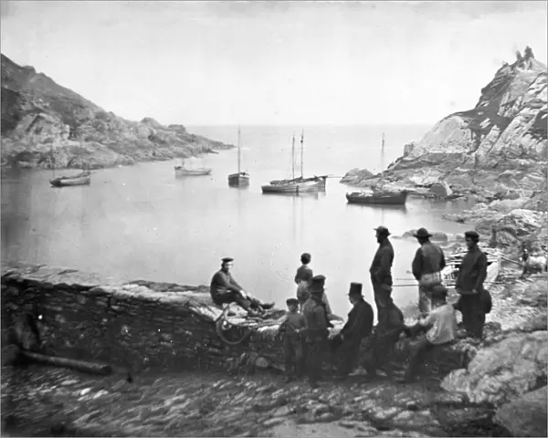 The outer harbour approach with boats off Chapel Rock, Polperro, Cornwall. Probably 1860s-1870s