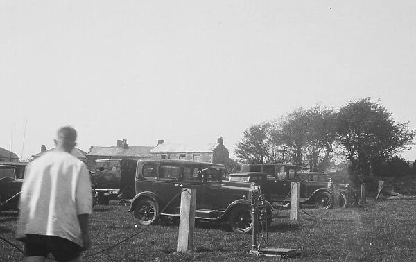 Cars parked in a field for a Cornish wrestling match at an unknown location, Cornwall. Around 1930s