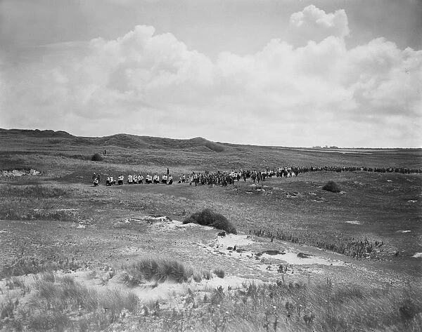 A distant view of Bishop Frere in procession to St Pirans Oratory, Perranzabuloe, Cornwall. Between 1923 and 1935
