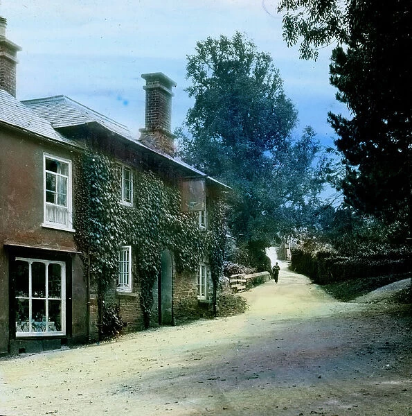 The Falcon Inn and view up hill with a postman walking towards the camera. St Mawgan in Pydar, Cornwall. Around 1925