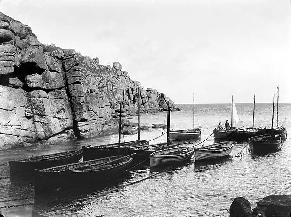 Two fishermen standing in their boat offshore, Porthgwarra, Cornwall. 1898
