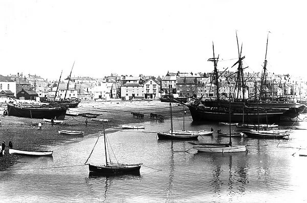 Fishing boats and schooners beached in St Ives harbour, Cornwall. Early 1900s