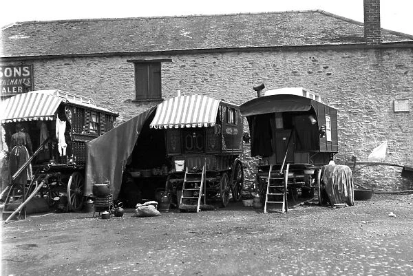 Gypsy caravans parked behind a merchants premises, Truro, Cornwall. 1900s
