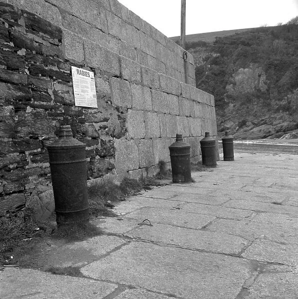 Harbour wall with cannon bollards, Polkerris, Tywardreath, Cornwall. 1976