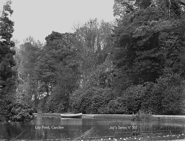 The lily pond with rowing boat at Carclew House, Mylor, Cornwall. 15th March 1912