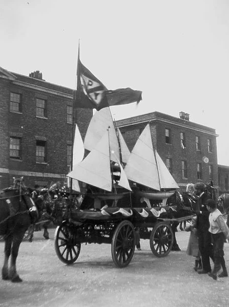 Model yachts being carted in procession through town, Newquay, Cornwall. Early 1900s