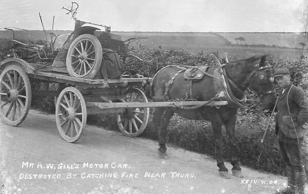 Mr A. W. Gills motor vehicle on a cart after being destroyed by fire. Liskey Hill, Perranporth, Cornwall. June 1906