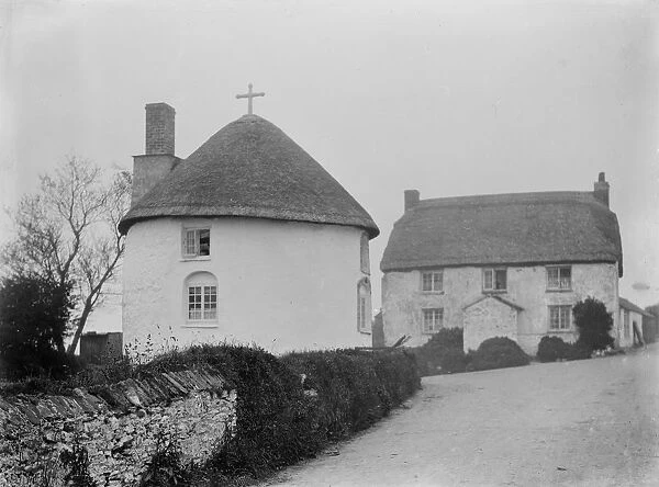 Thatched round house with a cross, Veryan Green, Veryan, Cornwall. 1910