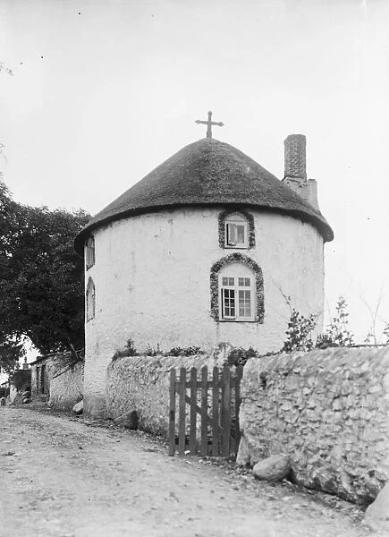 A white painted thatched round house with a cross, Veryan, Cornwall. 1911