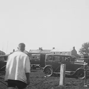 Cars parked in a field for a Cornish wrestling match at an unknown location, Cornwall. Around 1930s