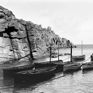 Two fishermen standing in their boat offshore, Porthgwarra, Cornwall. 1898