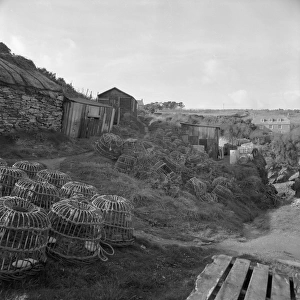 Fishermens huts and lobster pots, Prussia Cove, St Hilary, Cornwall. 1970