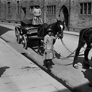 Members of the First World War Womens Land Army leading a horse and cart in Truro, Cornwall. Around 1917