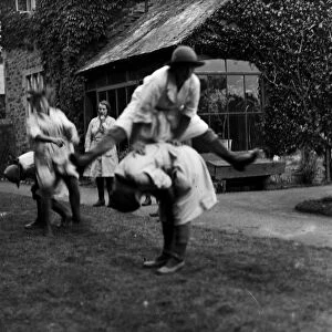 Members of the First World War Womens Land Army playing leap frog. Tregavethan Farm, Truro, Cornwall. 13th September 1918