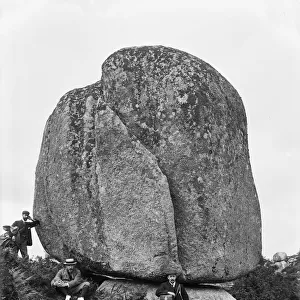 Three men by near a huge granite boulder, Luxulyan Valley, Cornwall. 1900