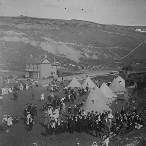 People and tents in a field near the beach, Porthtowan, Cornwall. Around 1900
