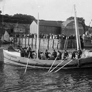 RNLI Padstow Lifeboat No. 2 Edmund Harvey with the tug Helen Peele alongside in the background, Padstow, Cornwall. 1901