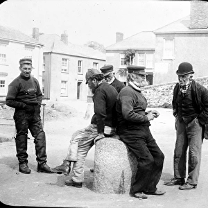 Seamen chat on the quayside, Flushing, Cornwall. 1890s