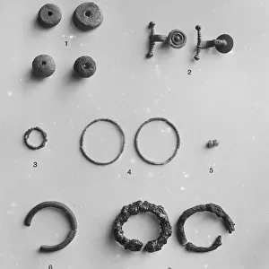 Spindle whorls, Iron Age brooches and various rings from the Iron Age cemetery at Harlyn Bay, St Merryn, Cornwall. 1900