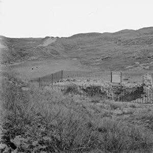 A view of St Pirans Oratory surrounded by railings, Perranzabuloe, Cornwall. Between 1890s and 1910