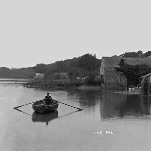 Village from the river with man rowing, Tresillian, Cornwall. 1890s