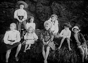 Perranporth Collection: Children posed on rocks on beach at Perranporth, Perranzabuloe, Cornwall. Around 1900