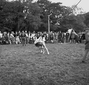 Wrestling Collection: A crowd of people gathered to watch a Cornish wrestling match at an unknown location, Cornwall. 1970