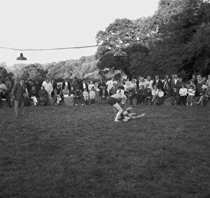 Wrestling Collection: A crowd of people gathered to watch a Cornish wrestling match at an unknown location, Cornwall. 1970
