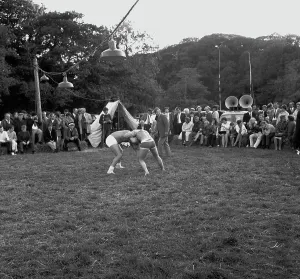 A crowd of people gathered to watch a Cornish wrestling match at an unknown location, Cornwall. 1970