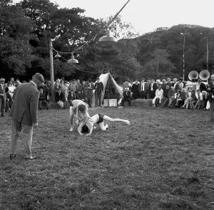 A crowd of people gathered to watch a Cornish wrestling match at an unknown location, Cornwall. 1970