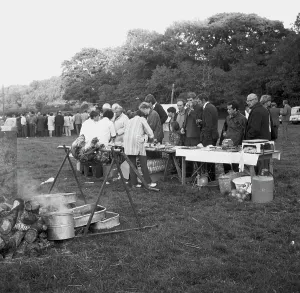 A crowd of people gathered to watch a Cornish wrestling match at an unknown location, Cornwall. 1970