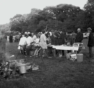 A crowd of people gathered to watch a Cornish wrestling match at an unknown location, Cornwall. 1970