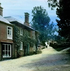 Trending: The Falcon Inn and view up hill with a postman walking towards the camera