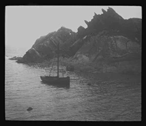 Fishing Collection: Fishing boat in a cove, probably Polperro, Cornwall. Around 1900