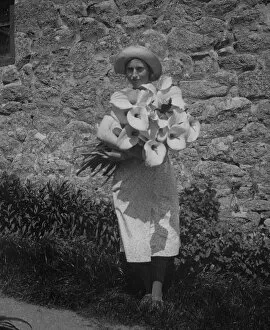 Isles of Scilly Collection: Girl with Arum lilies, Bryher, Isles of Scilly, Cornwall. 1910s