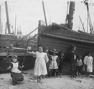 Images Dated 10th May 2016: A group of children with fishing vessels at St Ives harbour, Cornwall. Early 1900s