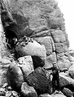 Images Dated 14th May 2018: Bill Harvey mending a lobster pot, Porthgwarra, Cornwall. 1903