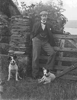 Images Dated 26th July 2018: Man with two dogs posed by gateway at St Saviours Point, Padstow, Cornwall. Early 1900s